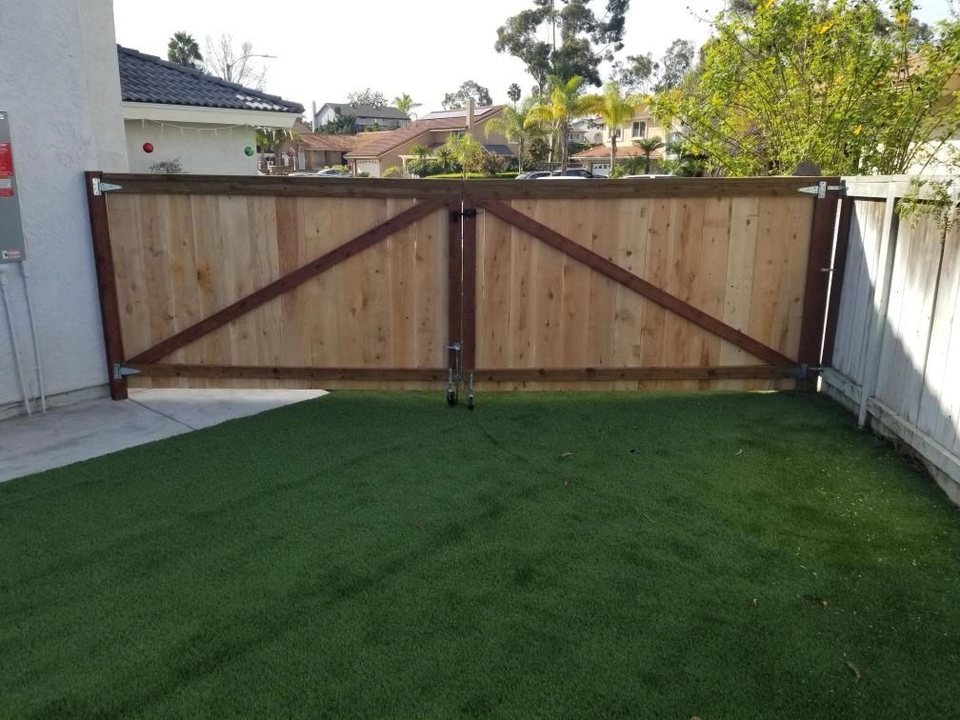 Custom wood driveway gate at a Chula Vista Fence project