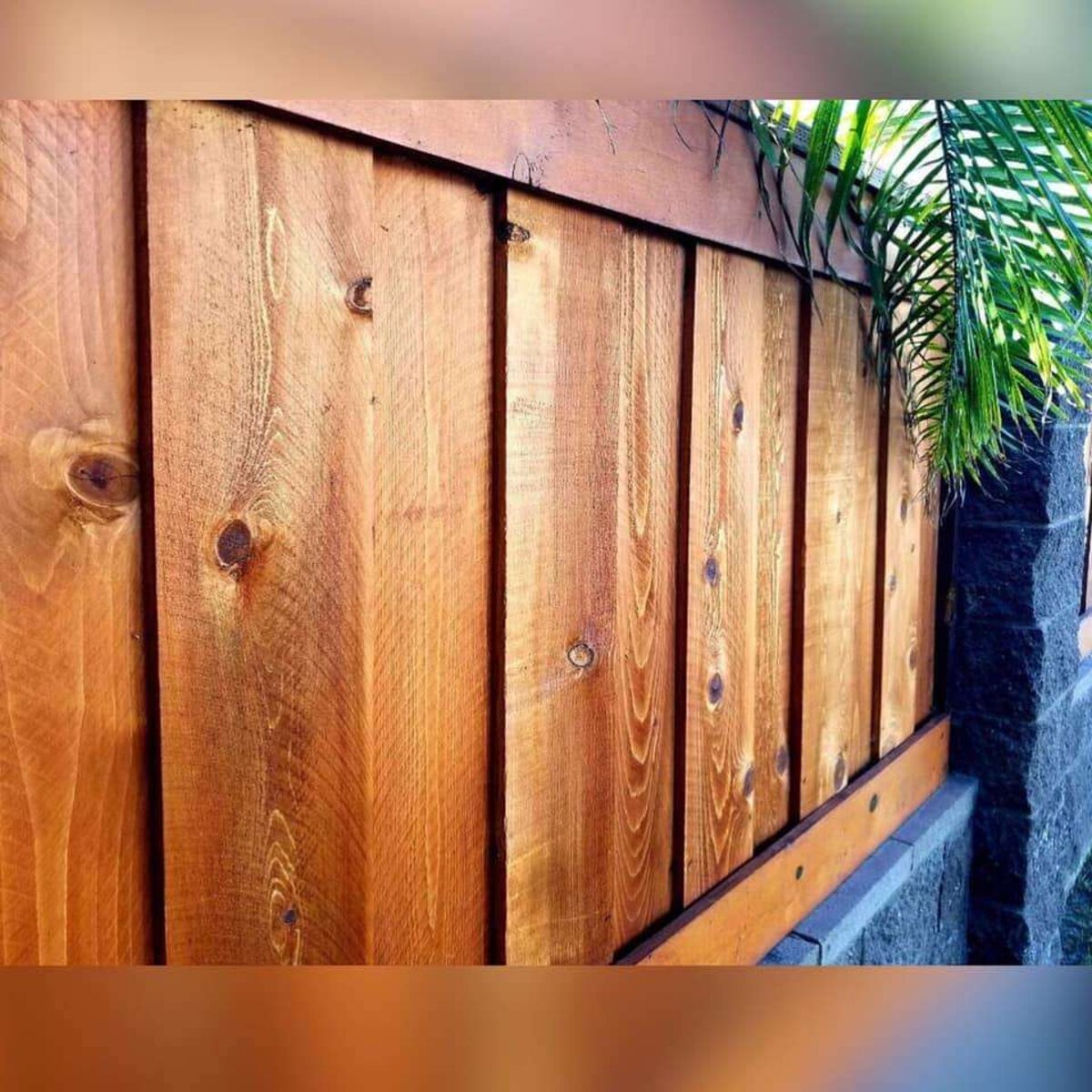 Close-up of a freshly sealed wood fence built by Chula Vista Fence